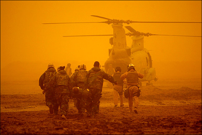 A United States Marine crew under sandstorms, north of the Euphrates, Iraq, late March 2003.